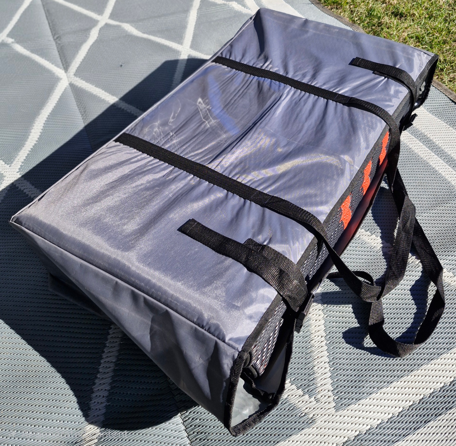 Rolled-up Mooving Mat inside its branded carry bag